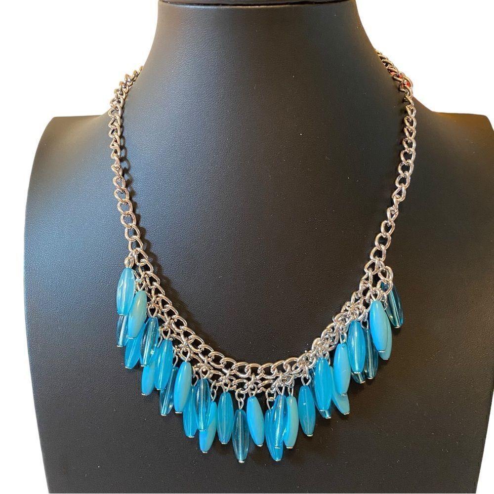 Turquoise Colored Beaded Necklace on Silver Toned Chain. Earrings included.